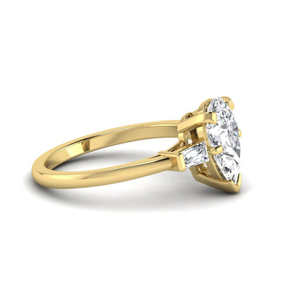 Pear cut lab grown diamond three stone engagement ring featuring a 2.31 carat IGI certified center diamond with tapered baguette side diamonds in yellow gold.