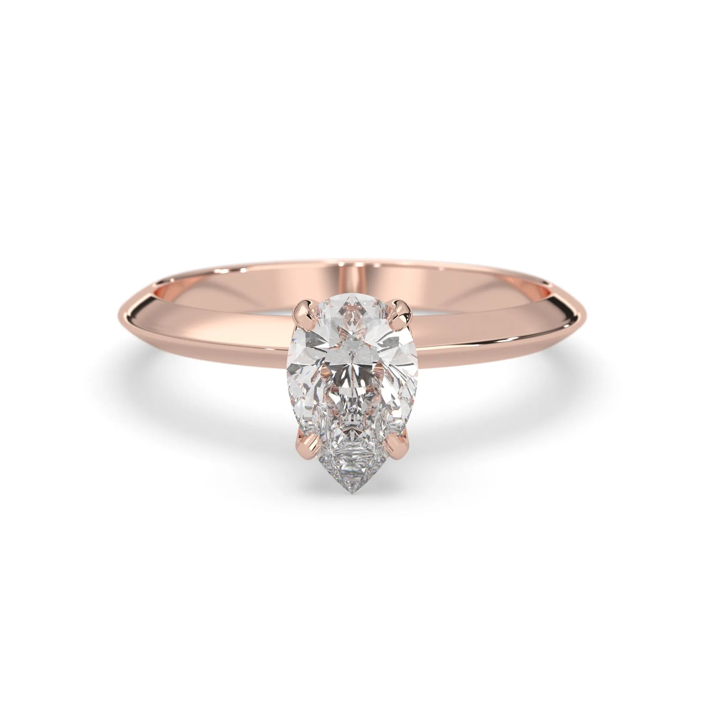 Rose-gold ring with a pear-shaped diamond on a white background