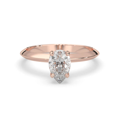 Rose-gold ring with a pear-shaped diamond on a white background