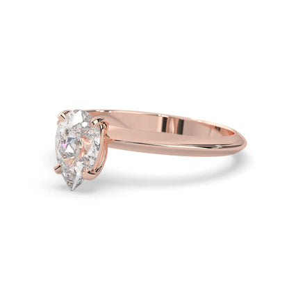 Rose-gold ring with a pear-shaped diamond on a white background