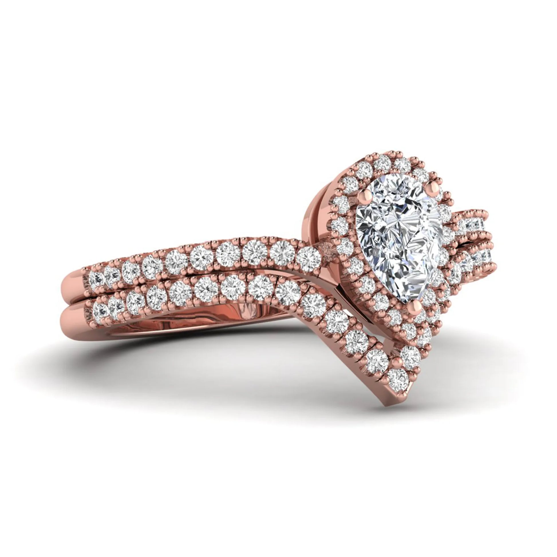 Pear cut lab grown diamond bridal ring set featuring a halo engagement ring with a matching curved pavé wedding band in a rose gold tone design.