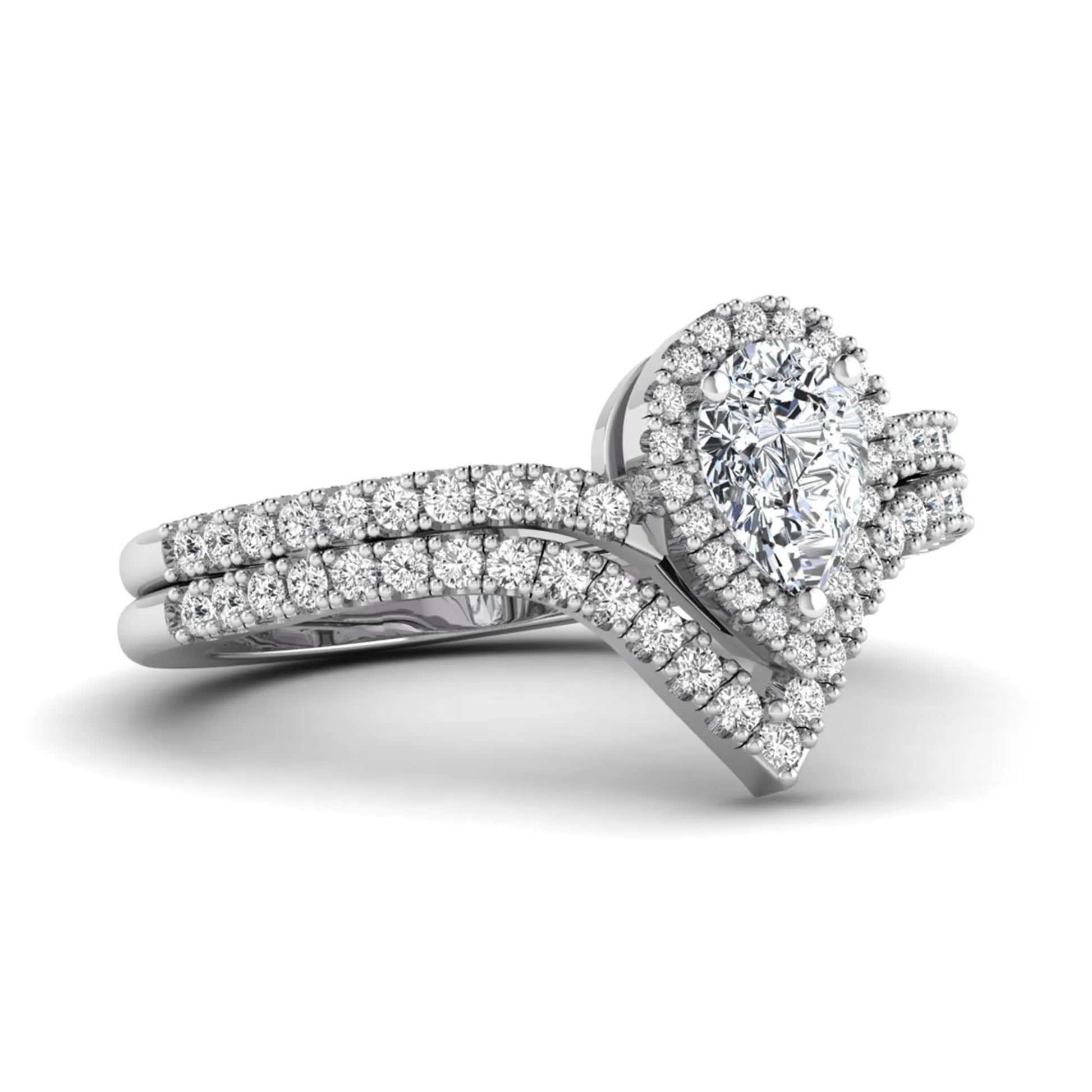 Pear cut lab grown diamond bridal ring set featuring a halo engagement ring with a matching curved pavé wedding band in a white gold tone design.
