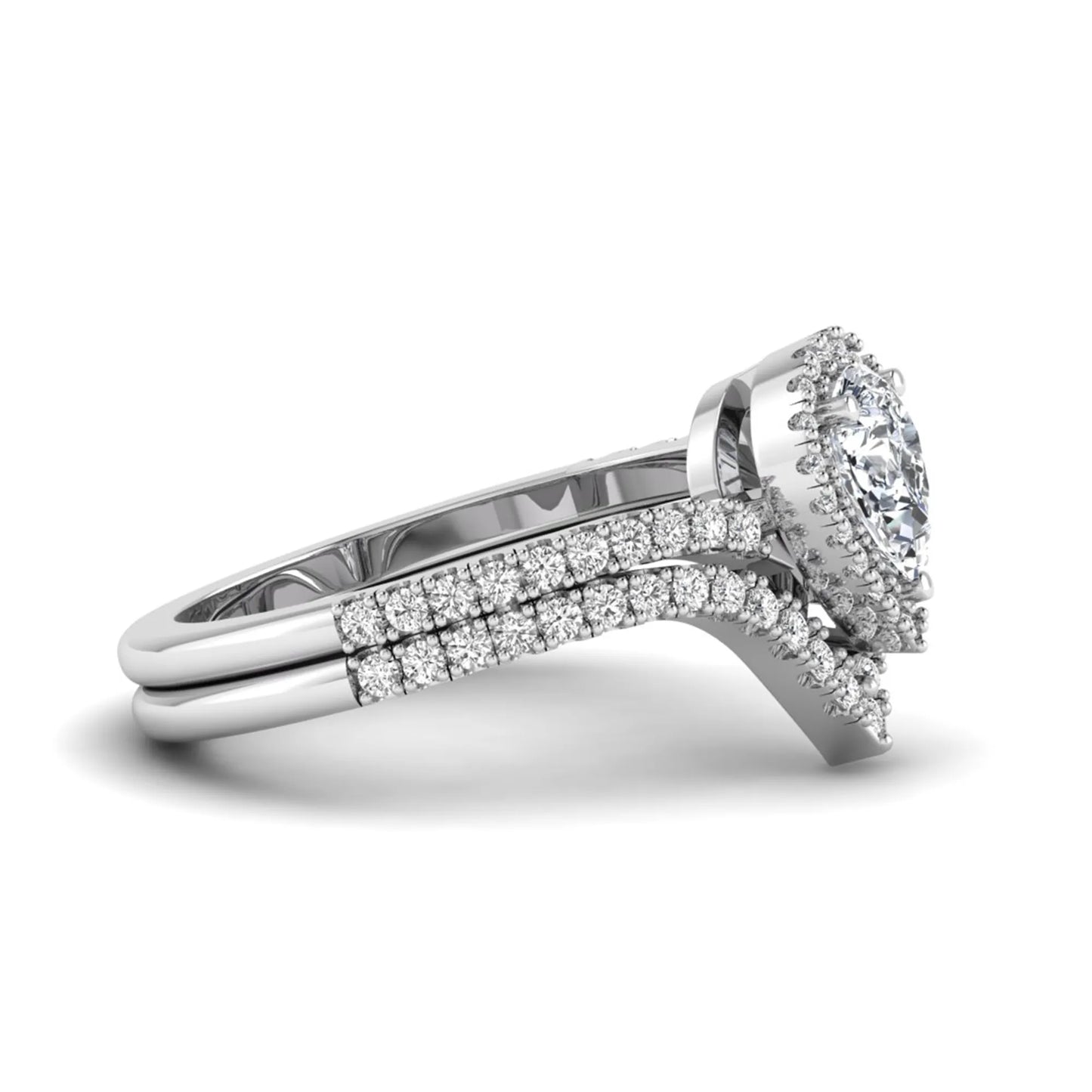 Pear cut lab grown diamond bridal ring set featuring a halo engagement ring with a matching curved pavé wedding band in a white gold tone design.