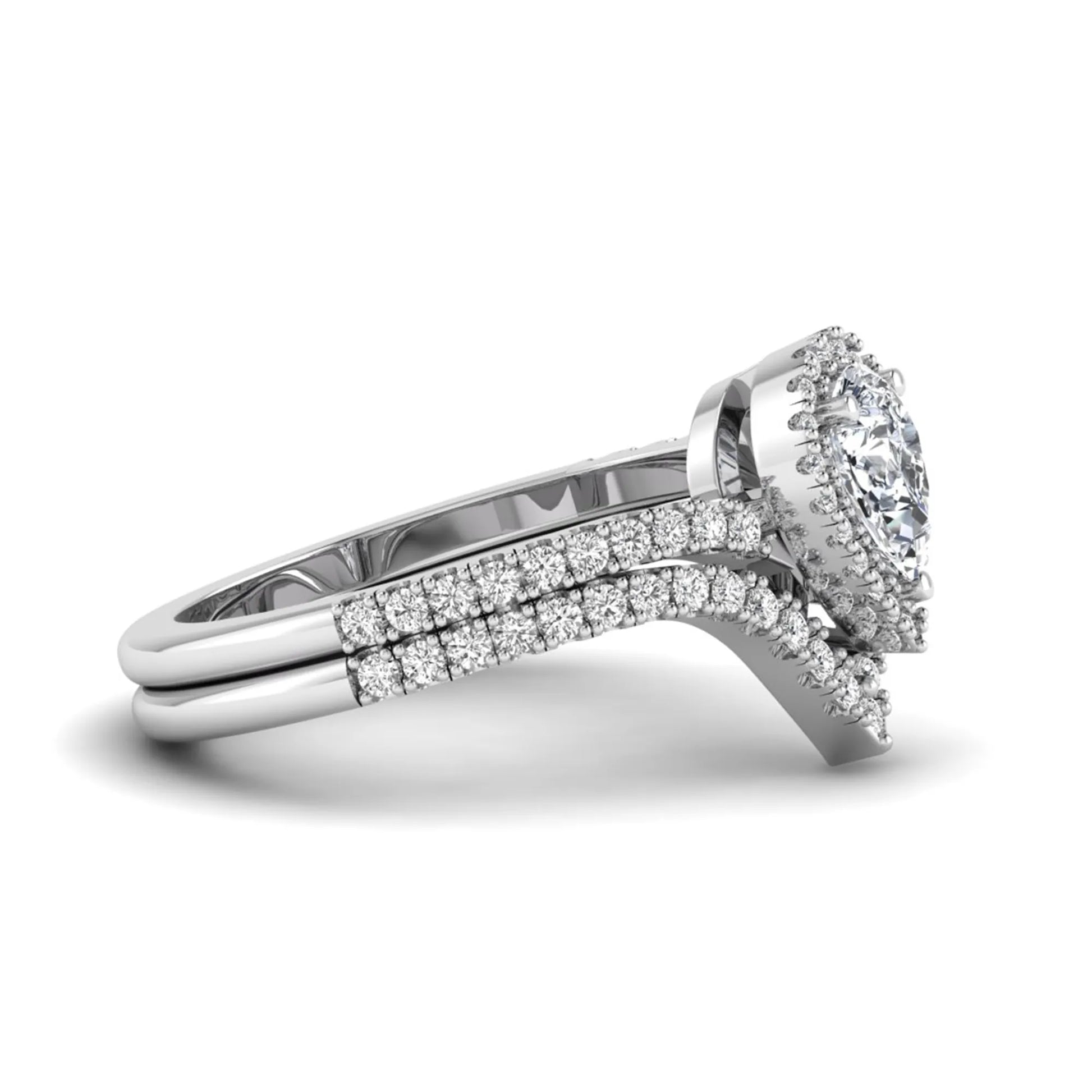 Pear cut lab grown diamond bridal ring set featuring a halo engagement ring with a matching curved pavé wedding band in a white gold tone design.