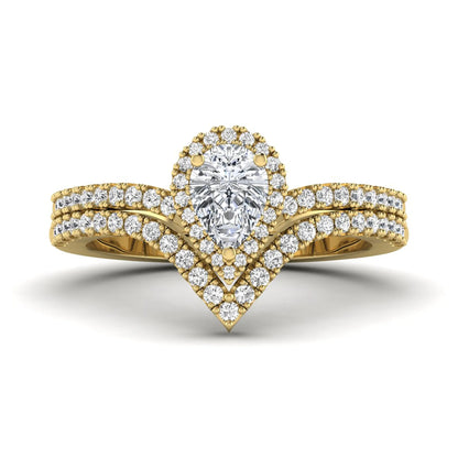 Pear cut lab grown diamond bridal ring set featuring a halo engagement ring with a matching curved pavé wedding band in a yellow gold tone design.
