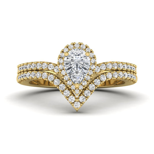 Pear cut lab grown diamond bridal ring set featuring a halo engagement ring with a matching curved pavé wedding band in a yellow gold tone design.