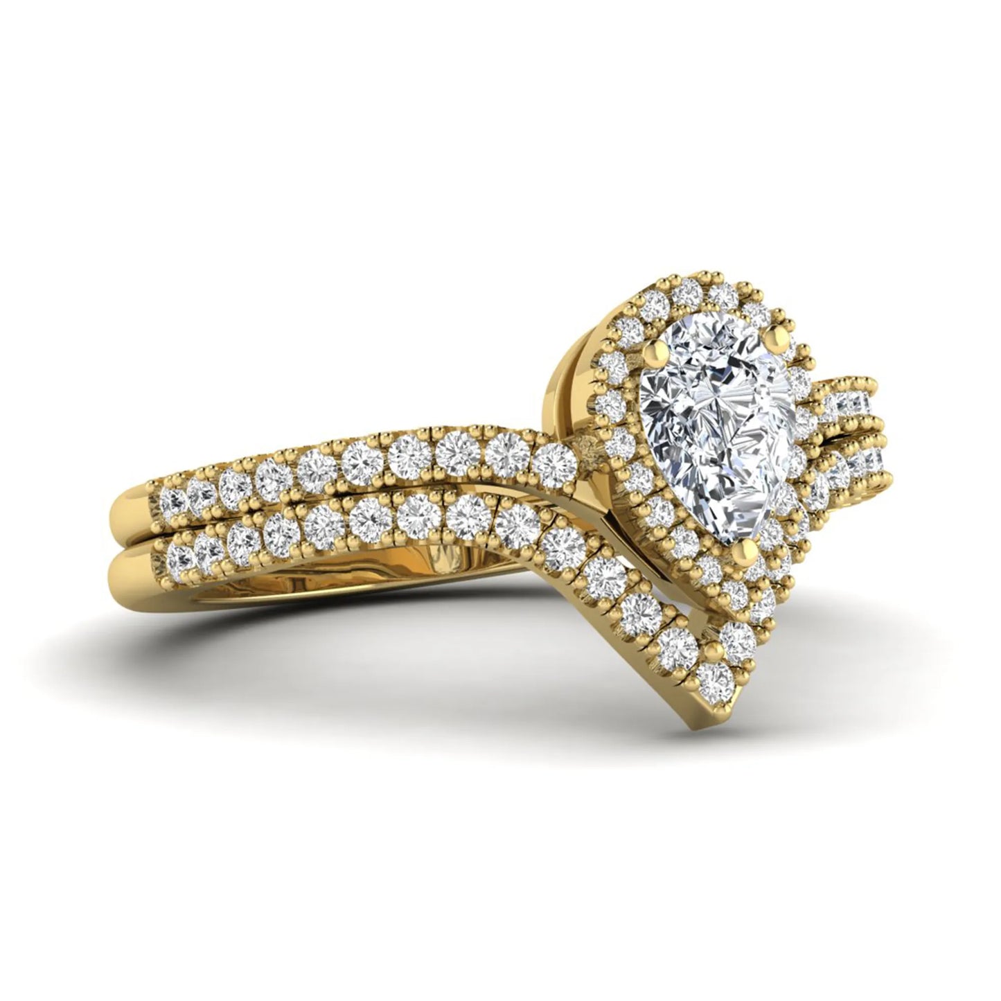 Pear cut lab grown diamond bridal ring set featuring a halo engagement ring with a matching curved pavé wedding band in a yellow gold tone design.