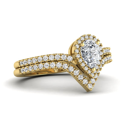 Pear cut lab grown diamond bridal ring set featuring a halo engagement ring with a matching curved pavé wedding band in a yellow gold tone design.