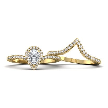 Pear cut lab grown diamond bridal ring set featuring a halo engagement ring with a matching curved pavé wedding band in a yellow gold tone design.