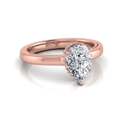 Pear cut lab grown diamond engagement ring featuring a hidden halo of round diamonds in a six-prong setting with a polished rose gold tone band.