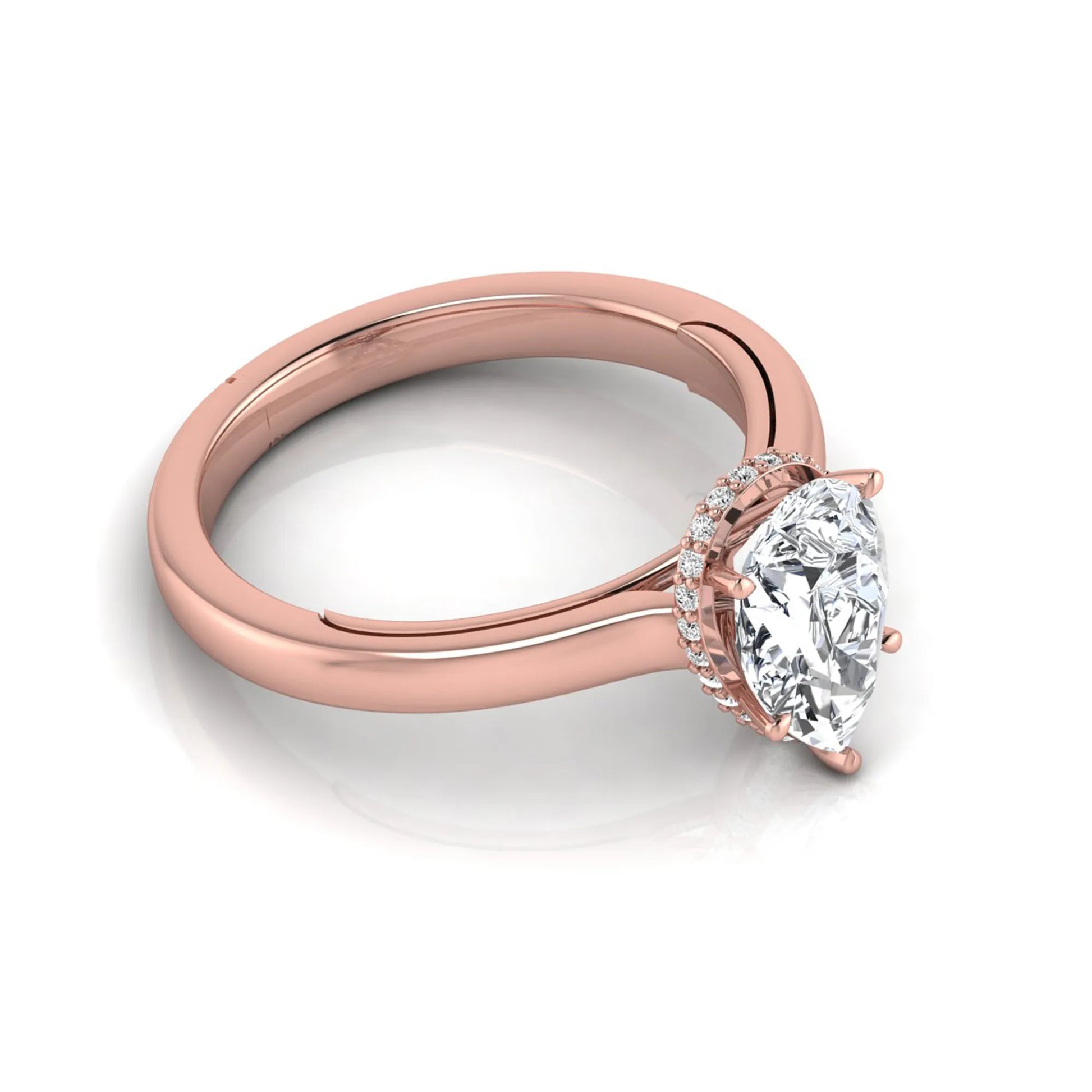 Pear cut lab grown diamond engagement ring featuring a hidden halo of round diamonds in a six-prong setting with a polished rose gold tone band.