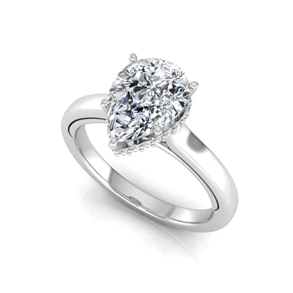 Pear cut lab grown diamond engagement ring featuring a hidden halo of round diamonds in a six-prong setting with a polished white gold tone band.