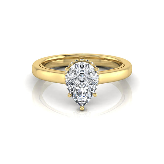 Pear cut lab grown diamond engagement ring featuring a hidden halo of round diamonds in a six-prong setting with a polished yellow gold tone band.
