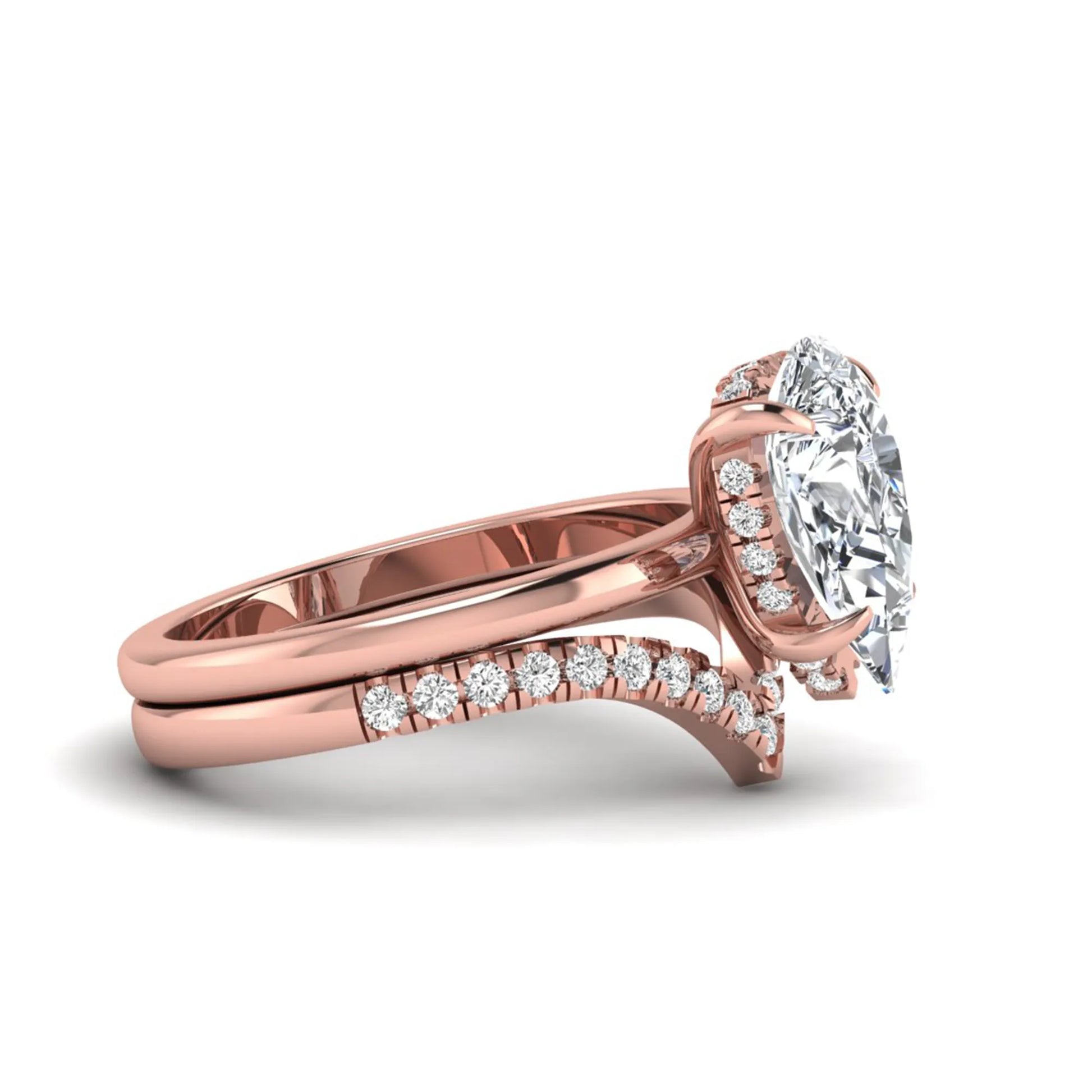 Pear cut lab grown diamond hidden halo solitaire bridal ring set featuring a four-prong engagement ring with a matching pavé chevron wedding band in rose gold.