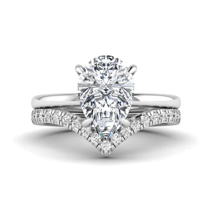 Pear cut lab grown diamond hidden halo solitaire bridal ring set featuring a four-prong engagement ring with a matching pavé chevron wedding band in white gold.