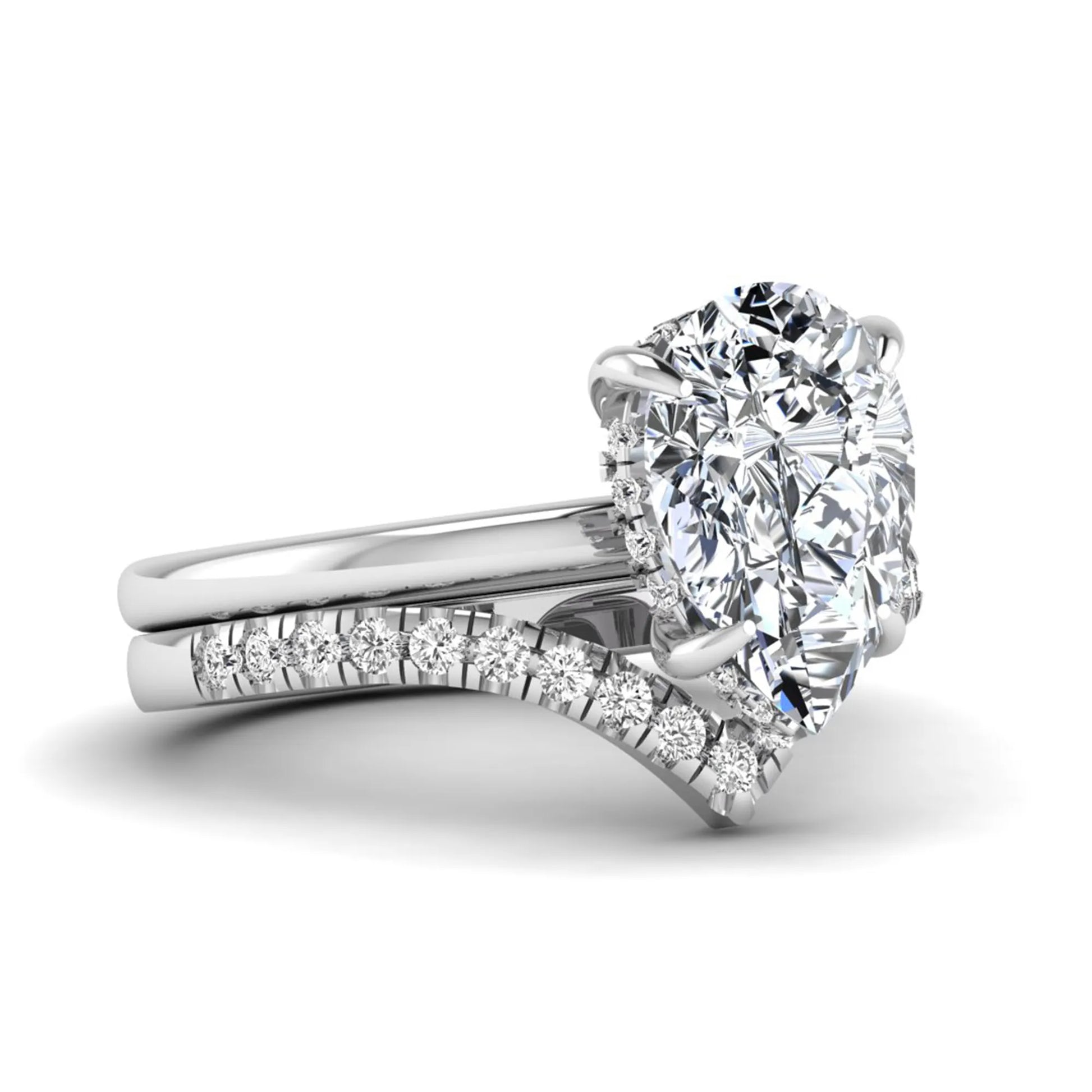Pear cut lab grown diamond hidden halo solitaire bridal ring set featuring a four-prong engagement ring with a matching pavé chevron wedding band in white gold.