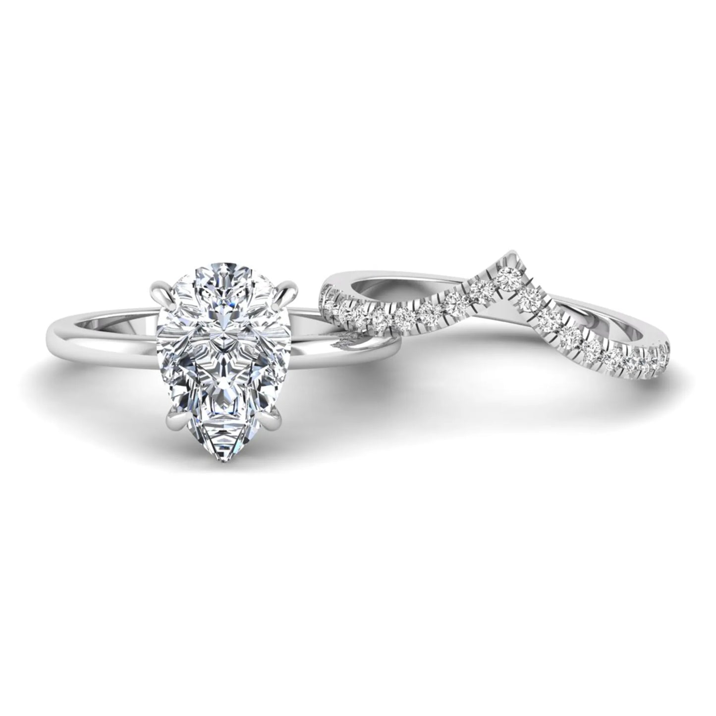 Pear cut lab grown diamond hidden halo solitaire bridal ring set featuring a four-prong engagement ring with a matching pavé chevron wedding band in white gold.