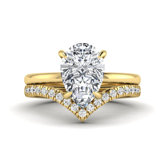 Pear cut lab grown diamond hidden halo solitaire bridal ring set featuring a four-prong engagement ring with a matching pavé chevron wedding band in yellow gold.