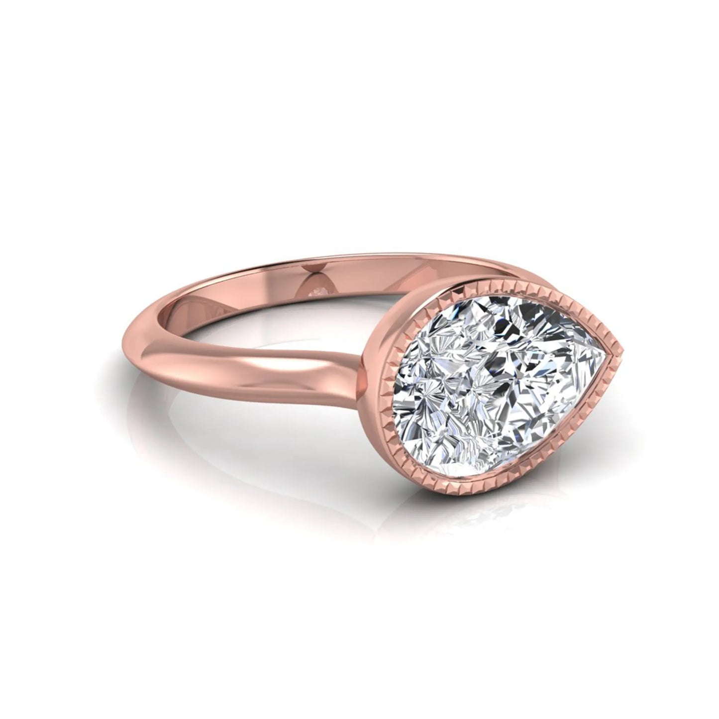 Pear cut lab grown diamond solitaire engagement ring featuring a milgrain bezel setting with a rose gold tone band.