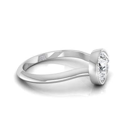Pear cut lab grown diamond solitaire engagement ring featuring a milgrain bezel setting with a white gold tone band.