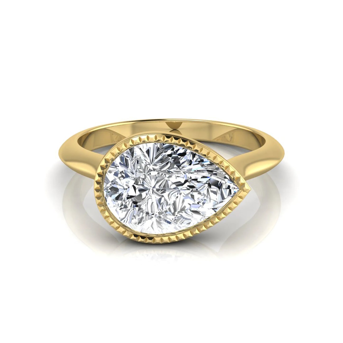 Pear cut lab grown diamond solitaire engagement ring featuring a milgrain bezel setting with a yellow gold tone band.