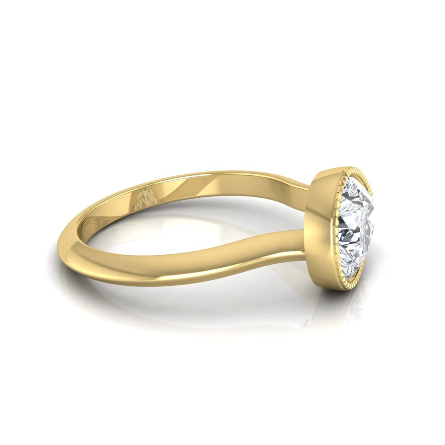 Pear cut lab grown diamond solitaire engagement ring featuring a milgrain bezel setting with a yellow gold tone band.