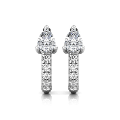 Pear cut lab grown diamond huggie hoop earrings featuring a three prong basket set center diamond with round brilliant pavé diamonds on a white gold hinged hoop.