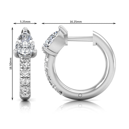 Pear cut lab grown diamond huggie hoop earrings featuring a three prong basket set center diamond with round brilliant pavé diamonds on a white gold hinged hoop.