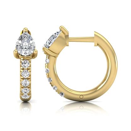 Pear cut lab grown diamond huggie hoop earrings featuring a three prong basket set center diamond with round brilliant pavé diamonds on a yellow gold hinged hoop.