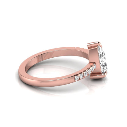 Pear cut lab grown diamond solitaire engagement ring featuring a three-prong setting with a pavé diamond band in rose gold tone.