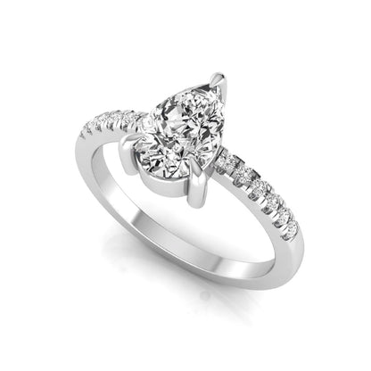 Pear cut lab grown diamond solitaire engagement ring featuring a three-prong setting with a pavé diamond band in white gold tone.
