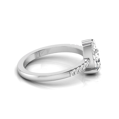Pear cut lab grown diamond solitaire engagement ring featuring a three-prong setting with a pavé diamond band in white gold tone.