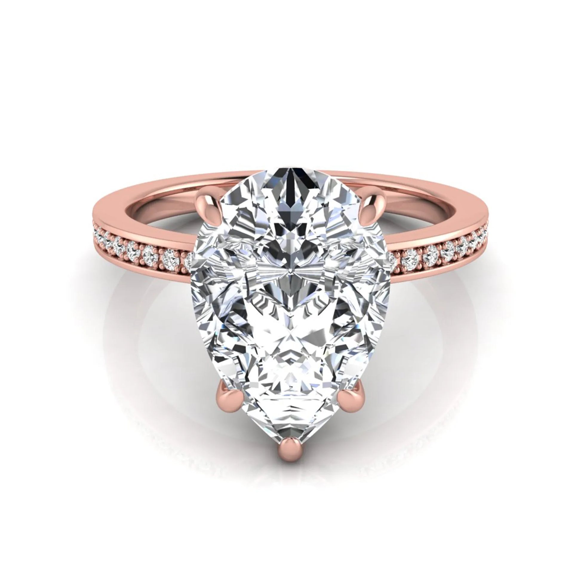Pear cut lab grown diamond solitaire engagement ring featuring a five-prong setting with a pavé diamond band in rose gold tone.