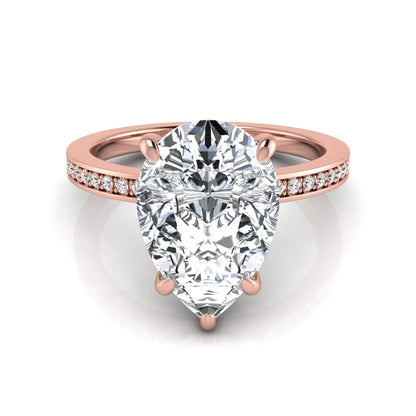Pear cut lab grown diamond solitaire engagement ring featuring a five-prong setting with a pavé diamond band in rose gold tone.
