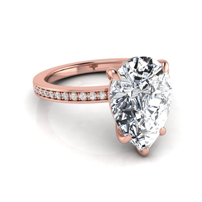 Pear cut lab grown diamond solitaire engagement ring featuring a five-prong setting with a pavé diamond band in rose gold tone.