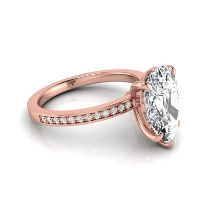 Pear cut lab grown diamond solitaire engagement ring featuring a five-prong setting with a pavé diamond band in rose gold tone.
