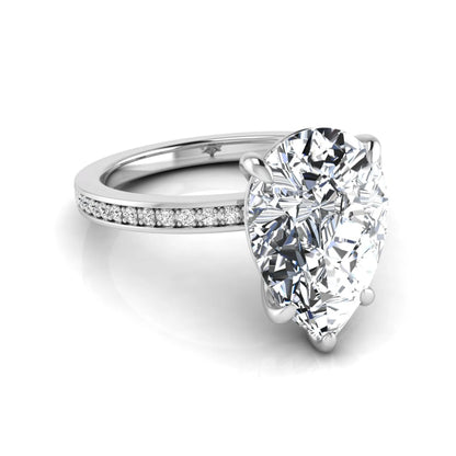Pear cut lab grown diamond solitaire engagement ring featuring a five-prong setting with a pavé diamond band in white gold tone.