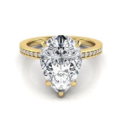 Pear cut lab grown diamond solitaire engagement ring featuring a five-prong setting with a pavé diamond band in yellow gold tone.