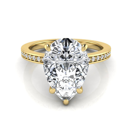 Pear cut lab grown diamond solitaire engagement ring featuring a five-prong setting with a pavé diamond band in yellow gold tone.