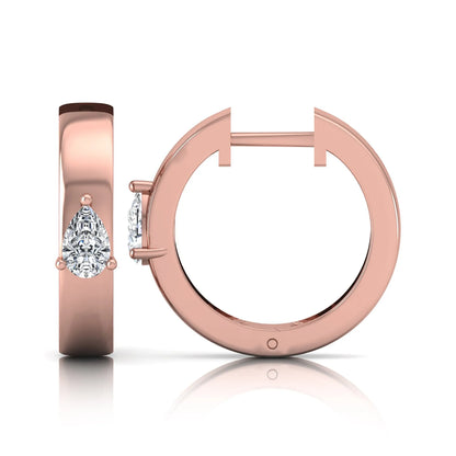 Pear cut lab grown diamond huggie hoop earrings with prong setting and hinged snap closure shown in rose gold tone for display.
