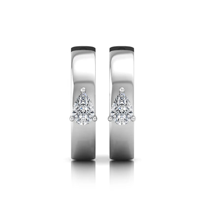Pear cut lab grown diamond huggie hoop earrings with prong setting and hinged snap closure shown in white gold tone for display.