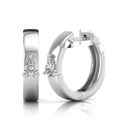 Pear cut lab grown diamond huggie hoop earrings with prong setting and hinged snap closure shown in white gold tone for display.
