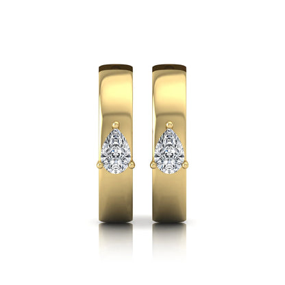 Pear cut lab grown diamond huggie hoop earrings with prong setting and hinged snap closure shown in yellow gold tone for display.