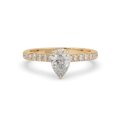 pear cut lab grown diamond prong set engagement ring with pavé band and yellow gold  metal tone design
