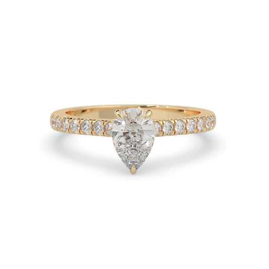 pear cut lab grown diamond prong set engagement ring with pavé band and yellow gold  metal tone design
