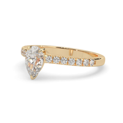 pear cut lab grown diamond prong set engagement ring with pavé band and yellow gold  metal tone design