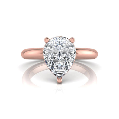Pear cut lab grown diamond solitaire engagement ring featuring a classic three-prong setting with a polished rose gold tapered band.