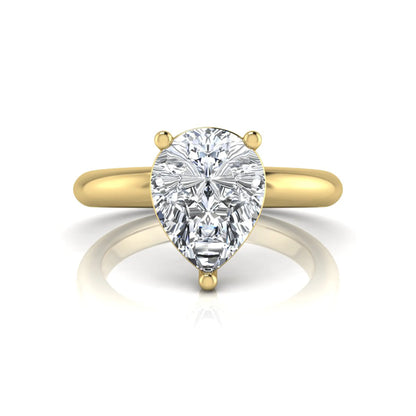 Pear cut lab grown diamond solitaire engagement ring featuring a classic three-prong setting with a polished yellow gold tapered band.
