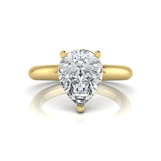 Pear cut lab grown diamond solitaire engagement ring featuring a classic three-prong setting with a polished yellow gold tapered band.