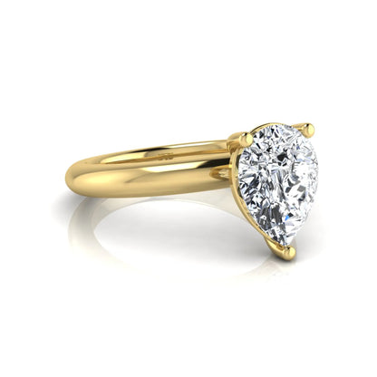 Pear cut lab grown diamond solitaire engagement ring featuring a classic three-prong setting with a polished yellow gold tapered band.